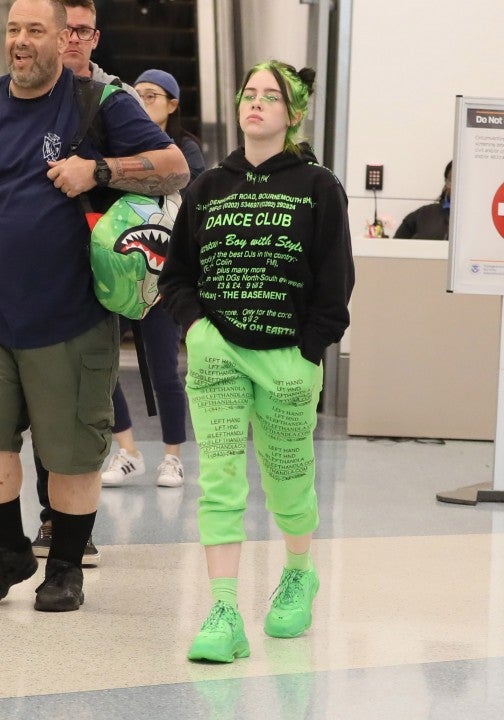 Billie Eilish at LAX in neon outfit
