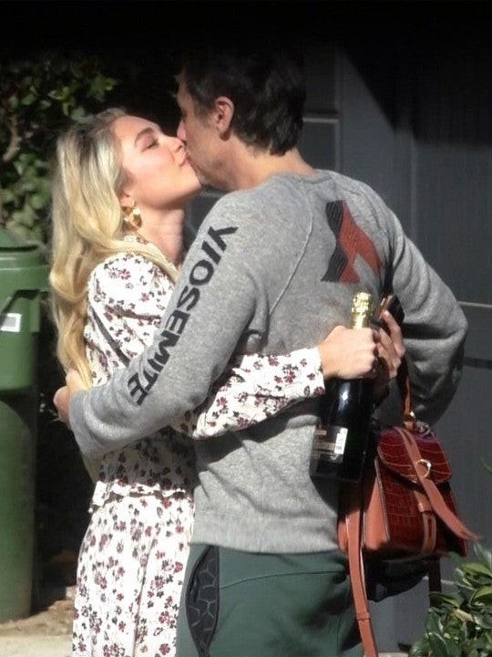 Florence Pugh clutches a bottle of champagne as she gets a kiss of congratulations from boyfriend Zach Braff after her Oscar nomination.