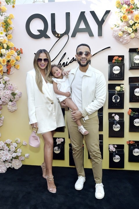 Chrissy Teigen and John Legend and daughter luna at quayxchrissy launch party