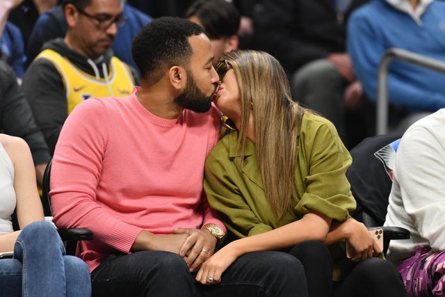 John Legend and Chrissy Teigen kiss at lakers game
