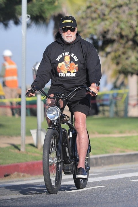 Arnold Schwarzenegger on bike in don't be an ass shirt