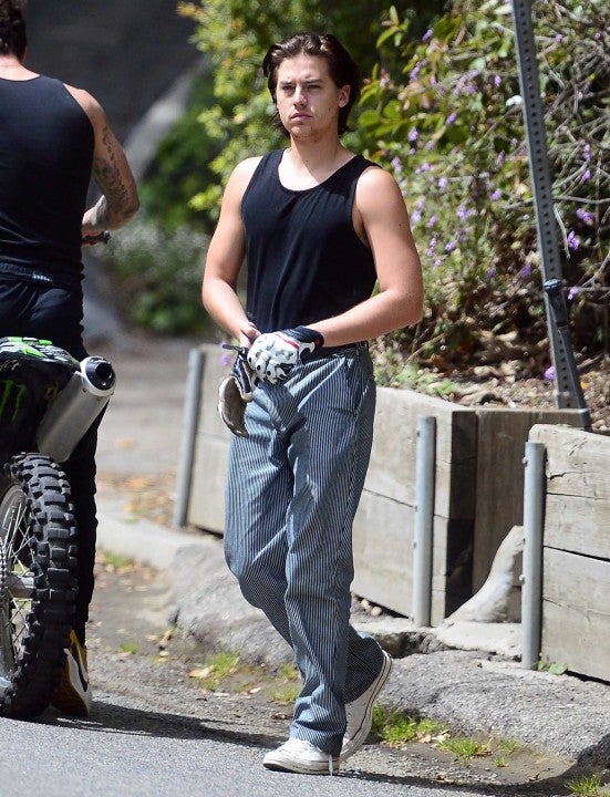 cole sprouse hops onto motorcycle