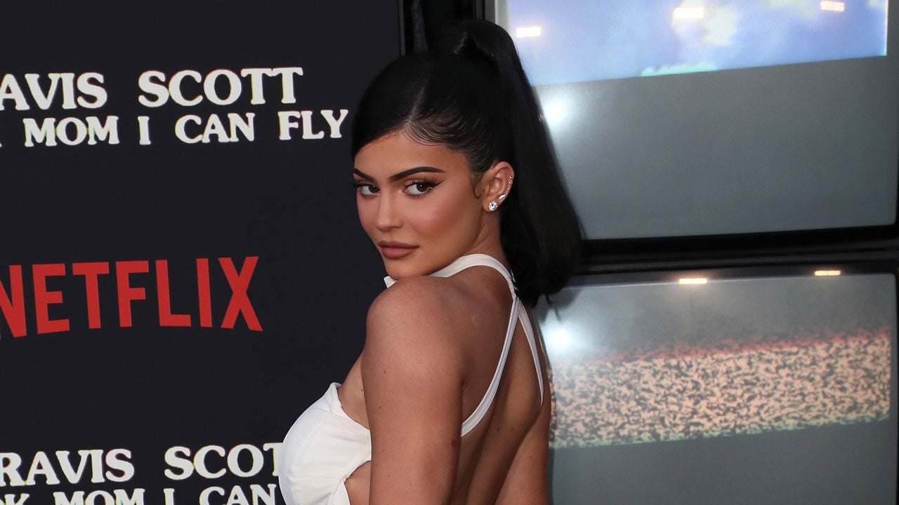 Kylie Jenner wears nude colored makeup as she models a headscarf
