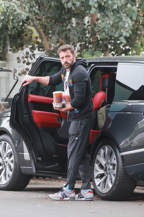 ben affleck with DD coffee in hand as he packs up his car in venice