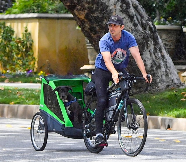 Shia LaBeouf bikes around with his dog