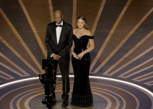 Morgan Freeman and Margot Robbie on stage at the Oscars