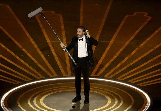 Jimmy Kimmel on stage with a boom mic