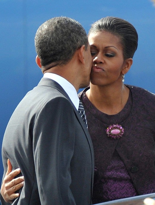 Michelle Obama kisses goodbye her husband US President Barack Obama as he boards Air Force One on the tarmac of Stansted airport near London 