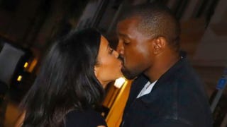 Kim Kardashian and Kanye West Kiss for the Cameras