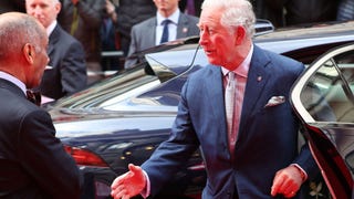 Watch Prince Charles Forget He's Not Supposed to Shake Hands